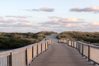 A boardwalk leads to the beach, reflecting how COVID lifestyle changes impact young Australians’ aspirations.