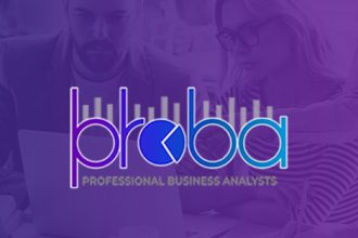 Business analysts work together on a laptop, offering solutions for organisations needing vet sector expertise.