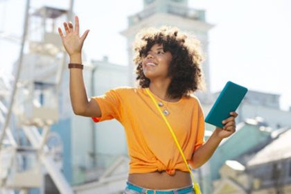 A woman uses a tablet at an amusement park, demonstrating how direct observation can apply to online learning environments.