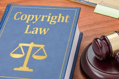 A law book and gavel illustrate copyright law and legal recourse for infringement.